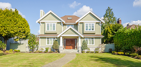 Two-story suburban house with green siding - https://www.auburninsurance.org